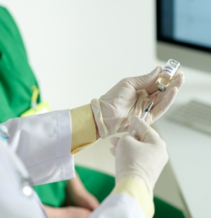Doctor Filling Syringe with Vaccine