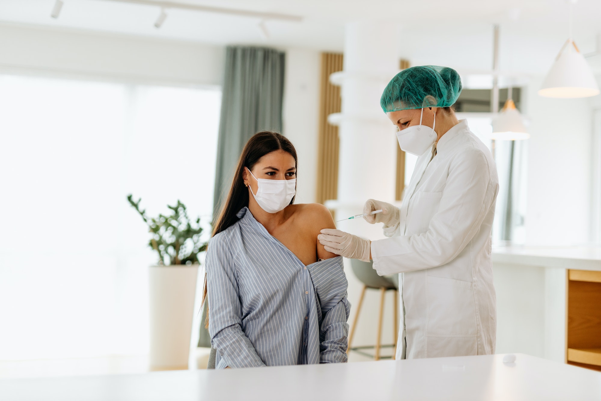 Health care, doctor holding needle and syringe.
